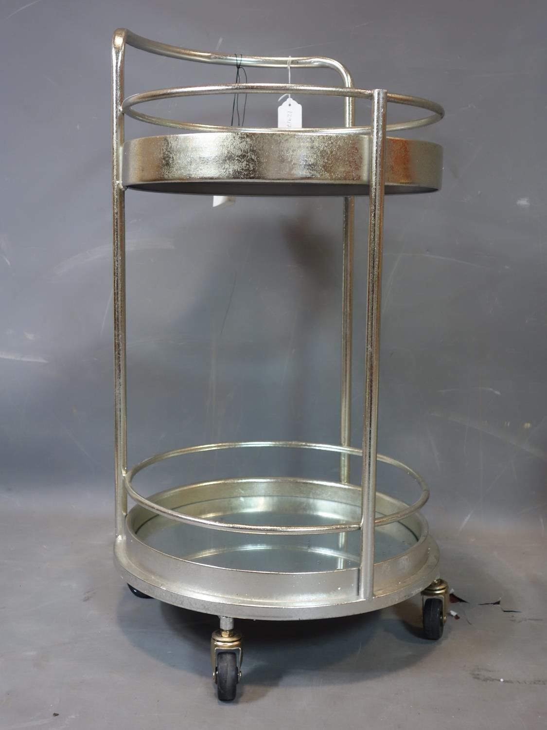 A contemporary silver painted circular two tier drinks trolley, with mirrored tops, raised on - Image 2 of 2