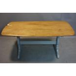 An Ercol elm dining table, on grey painted trestle supports, H.72 W.152 D.77cm