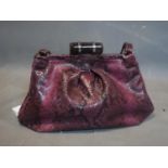 A Miu Miu purple snake skin handbag