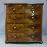 A 19th century figured mahogany bowfronted chest of two short over three long drawers, raised on bun