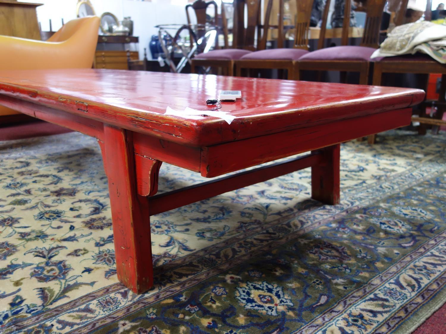 A large 20th century Chinese red lacquered coffee table, H.40 W.213 D.79cm - Image 3 of 3