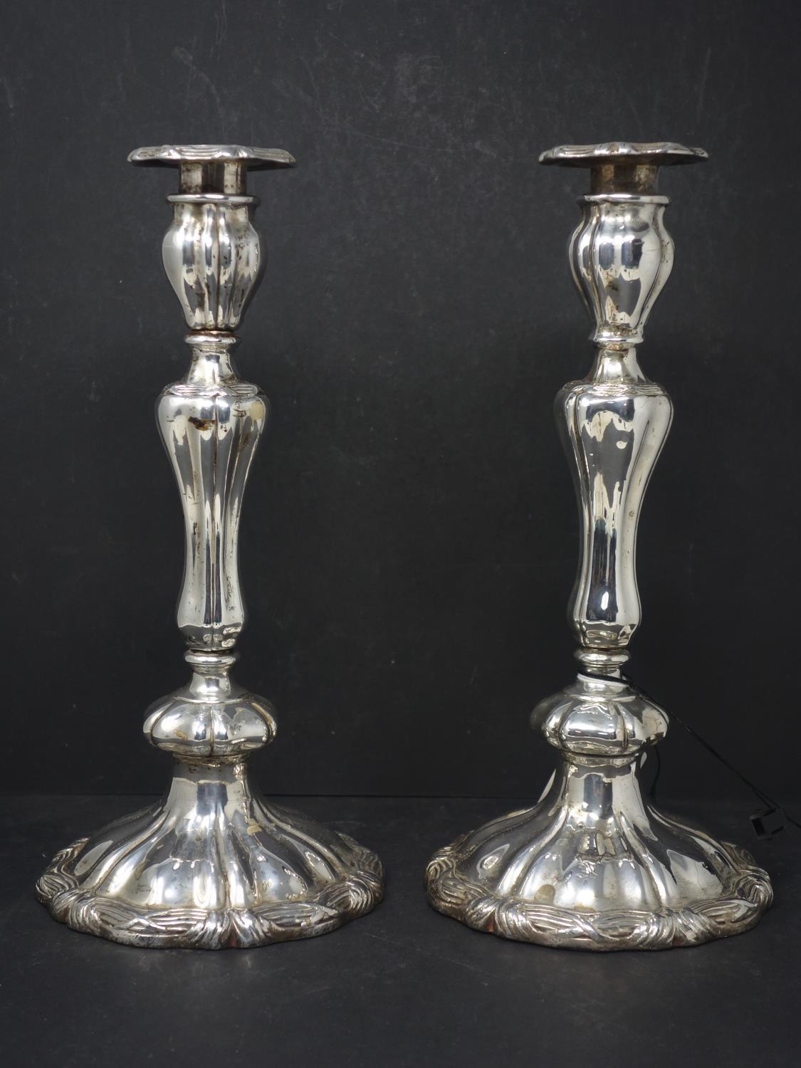 A pair of 19th century silver plated candlesticks, with knopped stem on spreading base, H.30cm