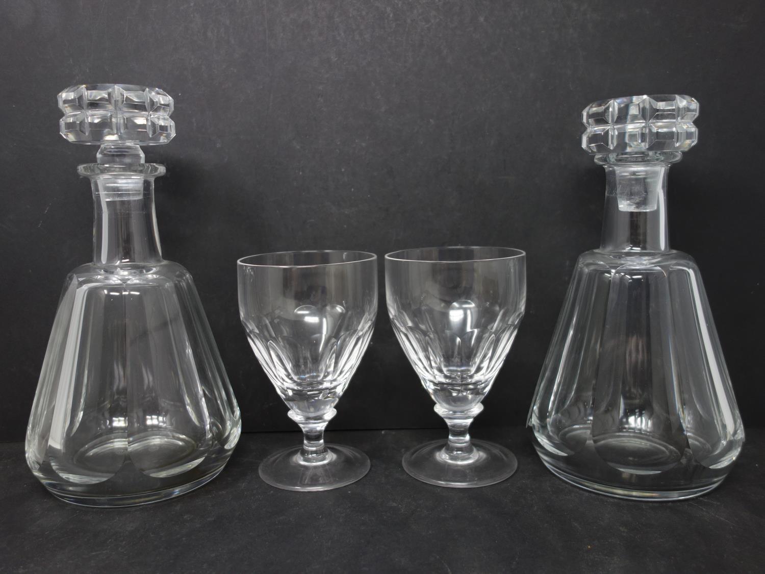 A pair of Baccarat crystal decanters, one with chipped stopper, together with a pair of William