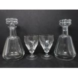 A pair of Baccarat crystal decanters, one with chipped stopper, together with a pair of William