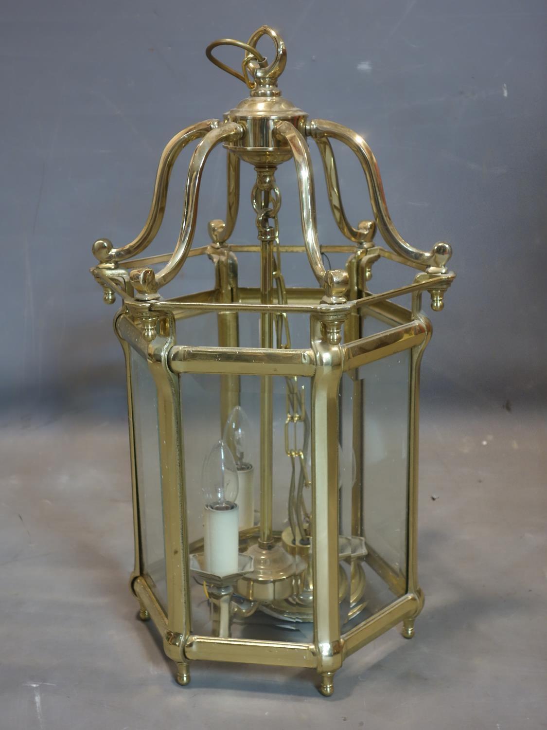 A heavy brass and glass hexagonal hanging ceiling lantern with bevelled glass panels, H.67 W.32 D.