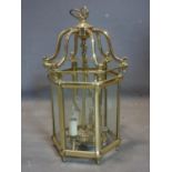 A heavy brass and glass hexagonal hanging ceiling lantern with bevelled glass panels, H.67 W.32 D.