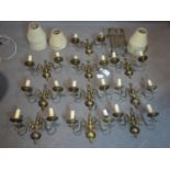 A collection of 10 brass two light wall sconces with shades, together with a brass trivet