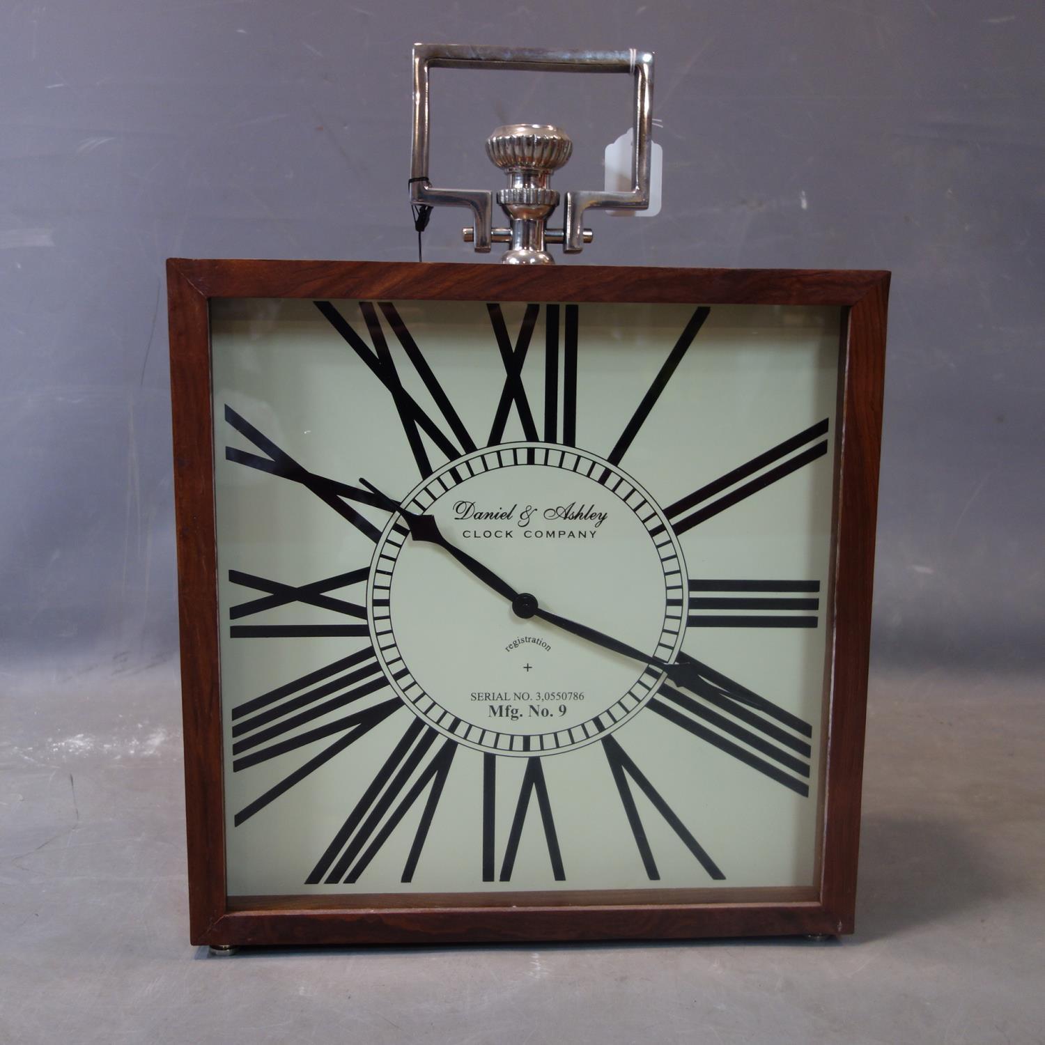 A contemporary clock, the Roman dial signed Daniel & Ashley Clock Company, battery operated, H.52