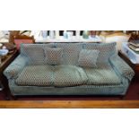 A three seater sofa with blue upholstery, raised on tapered oak feet