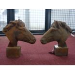 Two cast iron horse heads on block bases, H.30cm