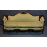 A 20th century French carved walnut bergere sofa