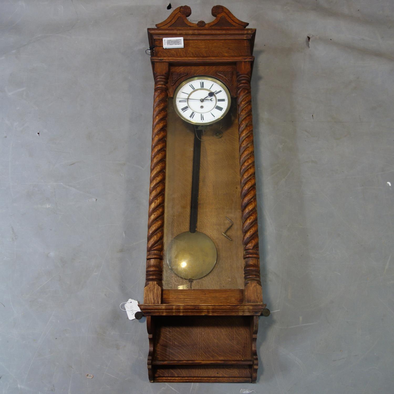 A 19th century Vienna regulator, white enamel dial with Roman numerals, with glazed door having twin