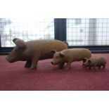 Three cast iron pigs of graduating size, H.18 W.45 D.15cm (3)