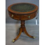A small Georgian style mahogany drum table, with green leather skiver above two short drawers, on