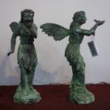 Two cast iron figures of fairies in the verdigris finish, to include one holding a bird and the