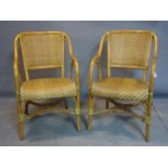A pair of bamboo and wicker conservatory chairs