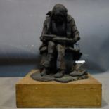 A 20th century resin and plaster sculpture of a seated girl reading, H.30cm