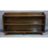 An oak low bookcase, raised on tapered feet, H.78 W.140 D.24cm