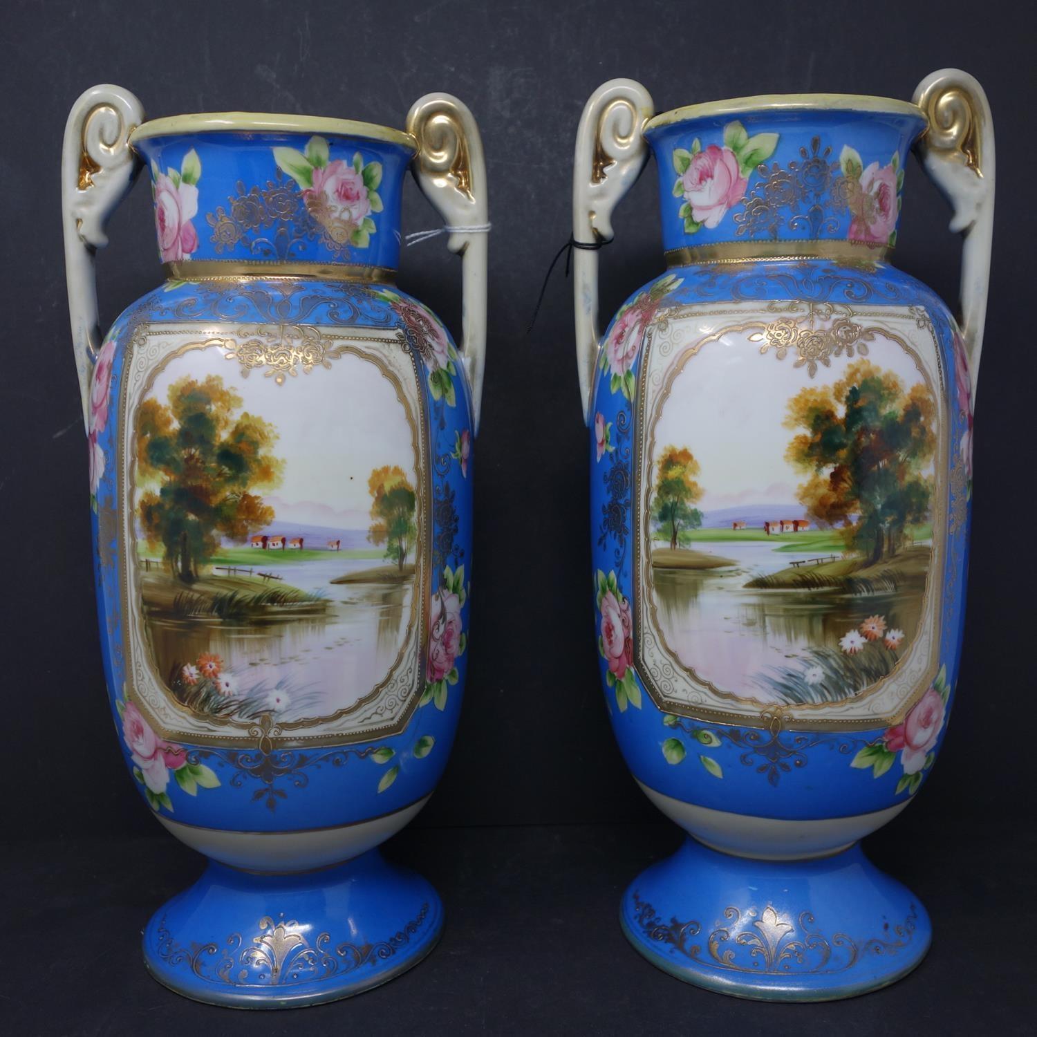 A pair of Japanese Noritake hand painted porcelain vases, H.33cm