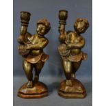 A pair of 20th century Indonesian carved gilt wood cherubs, H.64cm