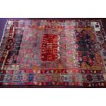 A Persian carpet with multi geometrical design, on a multi coloured ground, 242 x 165cm
