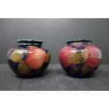 A near pair of early 20th century Moorcroft Pomegranate miniature vases, H.6cm