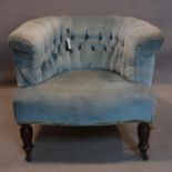 A Victorian mahogany tub chair, with blue button back velour upholstery, raised on turned legs and