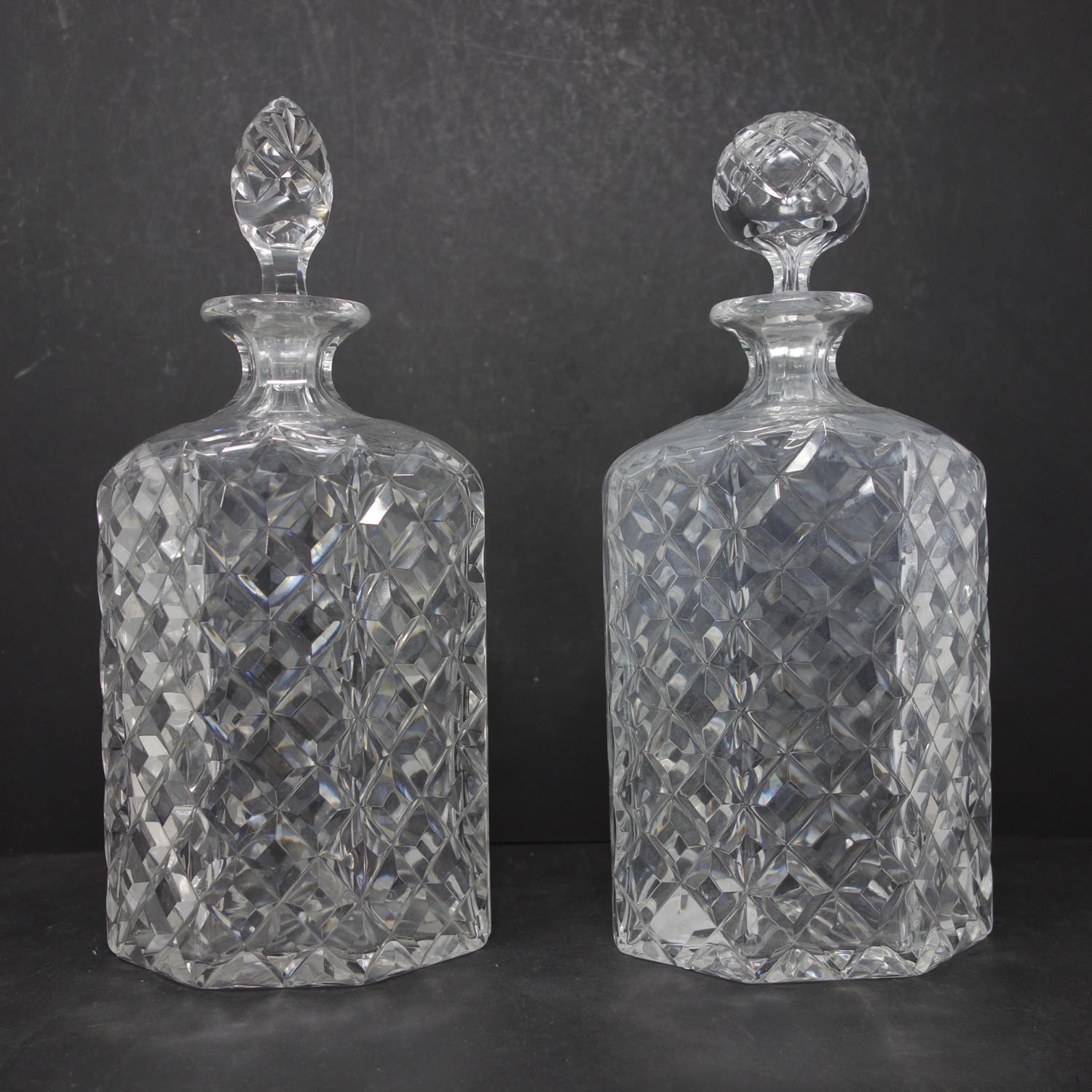 A pair of vintage crystal decanters, one with replaced stopper, H.26.5cm and H.27cm