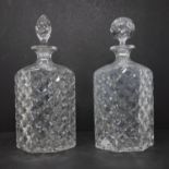 A pair of vintage crystal decanters, one with replaced stopper, H.26.5cm and H.27cm