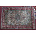 A part silk Persian Isfahan rug, central floral medallion and floral motifs on a cream ground,
