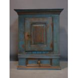 A 19th century Continental oak blue distressed painted cupboard, with single door above short