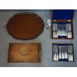 A mahogany tray with silver handles and feet together with another tray and silver plated box of