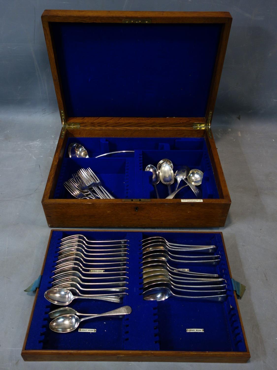 An Elkington canteen of silver plated cutlery, in oak case, to include dessert spoons, forks,