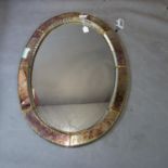 An oval Venetian style mirror. H.103 W.72cm (some damage to frame)