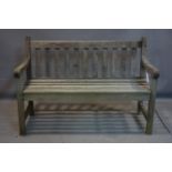 A weathered teak garden bench