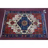 A Northwest Persian Nahawand rug, central pendant double medallion with repeating petal motifs on an