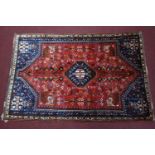 A Southwest Persian Qashqai rug, central diamond medallion with repeating petal motifs on a