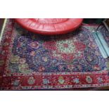 A Persian Tabriz carpet, the central floral medallion surrounded by floral motifs, on a blue ground,