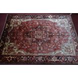 A Northwest Persian Heriz carpet, central diamond medallion with repeating petal motifs on a