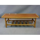 A teak coffee table, with undertier rack, H.35 W.111 D.46cm
