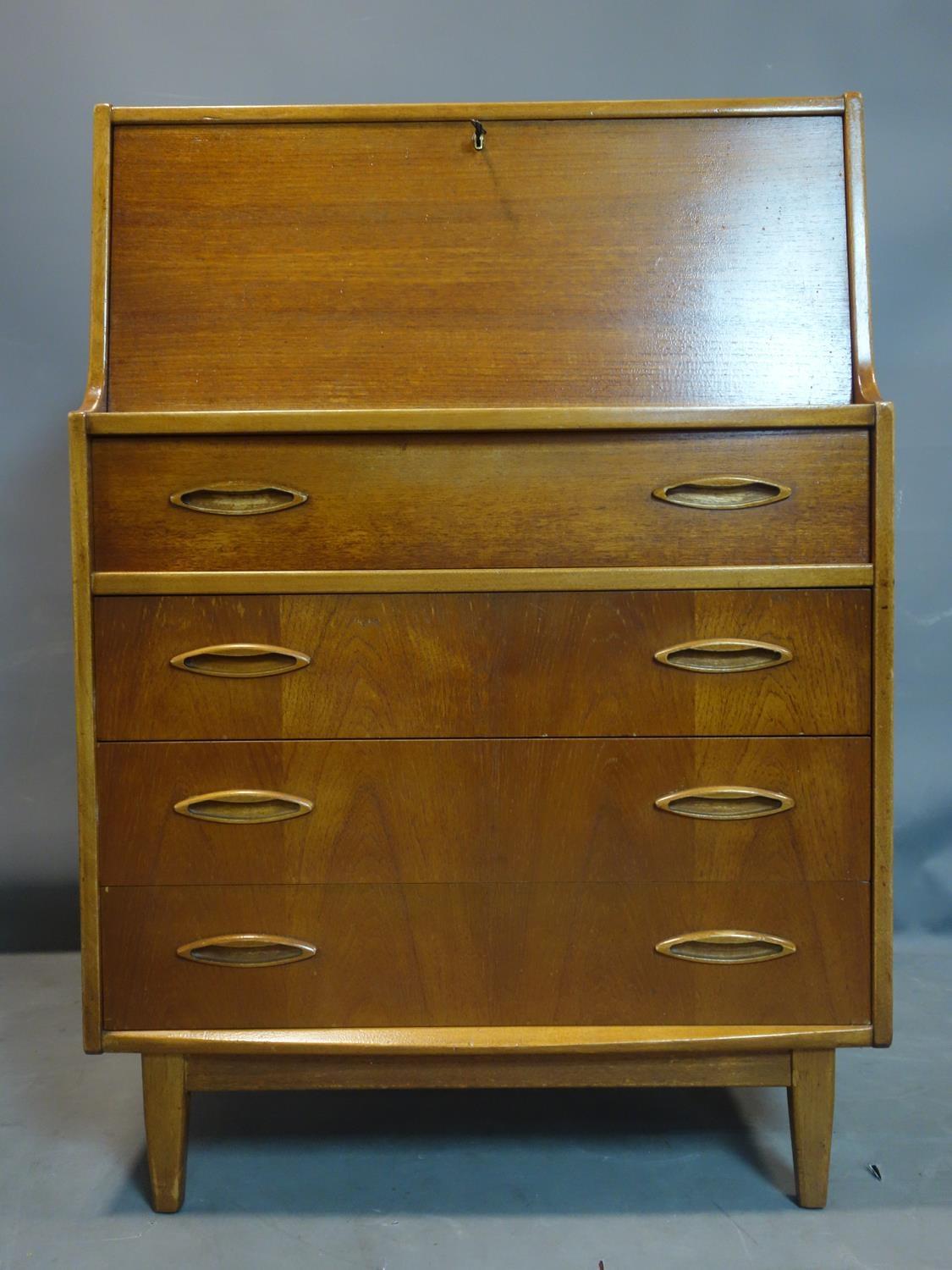 A teak bureau with drop flap above four drawers, on tapered feet, H.107 W.76 D.41cm