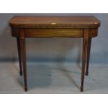A 19th century ebony inlaid mahogany tea table, raised on reeded tapered legs and spade feet, H.73