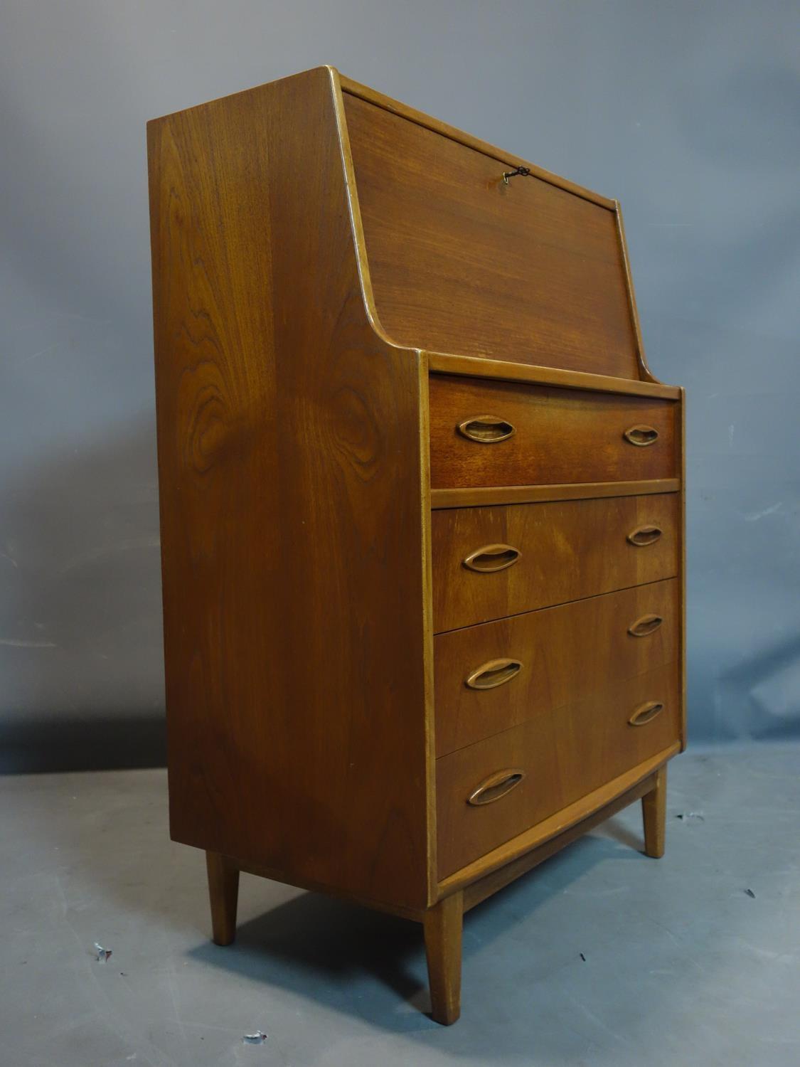 A teak bureau with drop flap above four drawers, on tapered feet, H.107 W.76 D.41cm - Image 3 of 3