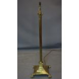 A Victorian cast brass Corinthian column standard lamp, raised on stepped square base with lion