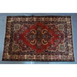 A Northwest Persian Lilihan rug, central double pendant medallion with repeating petal motifs on a