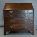 A George III mahogany bureau, having two short over two long drawers, with hinged lid revealing
