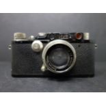 A vintage Leica ernst leitz wetzlar drp no 132212 camera, with original leather case fitted with a