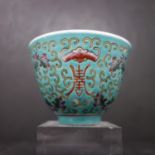 A 19th century Chinese tea cup, with enamelled decoration of bats and scrolling foliage, bearing six
