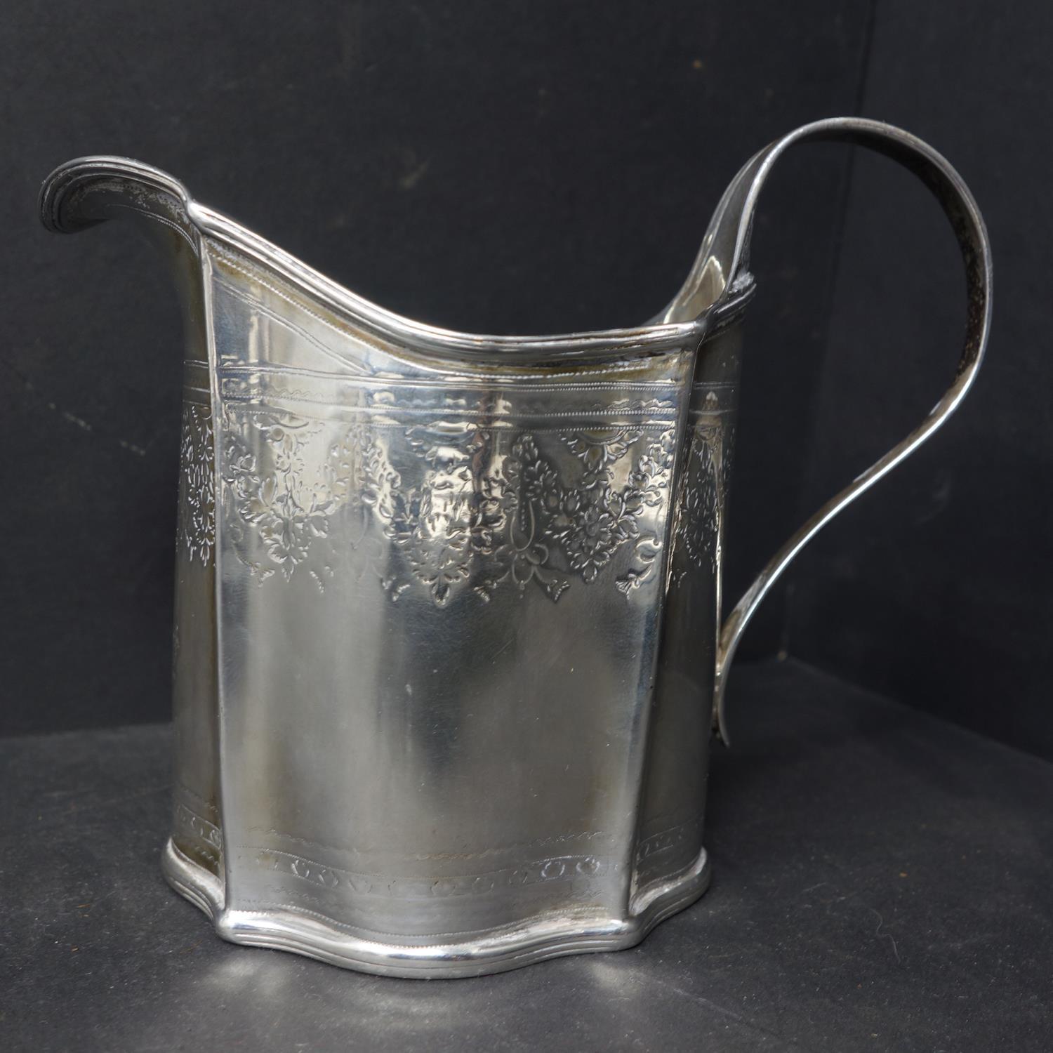 A Georgian silver milk jug, with engraved floral decoration, indistinctly hallmarked, H.10.5cm, - Image 2 of 6