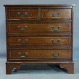 A small inlaid mahogany bachelors chest of two short over three long drawers, raised on bracket